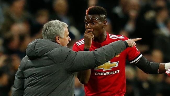 Manchester United's Portuguese manager Jose Mourinho (L) talks with Paul Pogba (R)