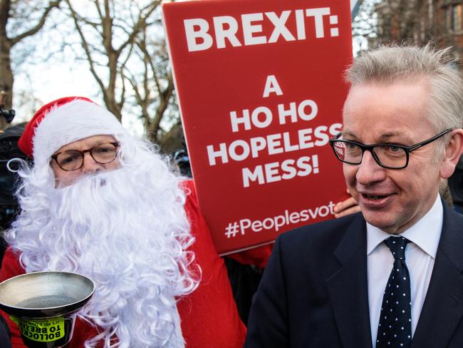 Environment Secretary Michael Gove is accosted by a protester in a Father Christmas outfit after speaking to the media in Westminster. Picture: Getty