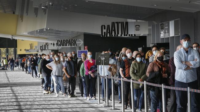 Crowds flock to vaccine hubs to get the jab after the Covid lockdown was announced at the Melbourne Exhibition Centre Picture: David Caird