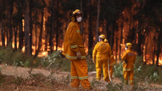 A CFA crew monitors a bushfire in Tynong North. Picture: Alex Coppel