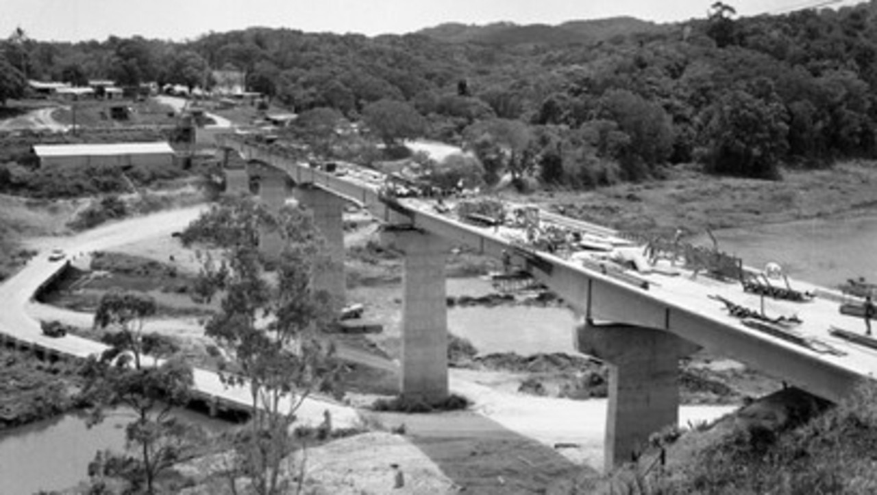 A historic photo prior to 1963 showing construction of the Barron River bridge and the low set crossing of the river. Picture: Cairns Libraries