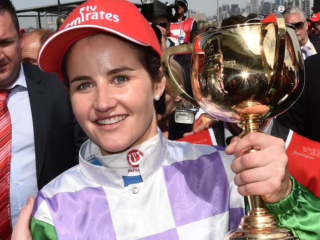 Michelle Payne celebrates after winning the Melbourne Cup on Prince of Penzance at Flemington Racecourse in Melbourne, Tuesday, Nov. 3, 2015. (AAP Image/Julian Smith) NO ARCHIVING, EDITORIAL USE ONLY