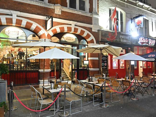 Empty seats and tables are seen outside bars near the Covent Garden area of London on December 21, 2021. Picture: AFP