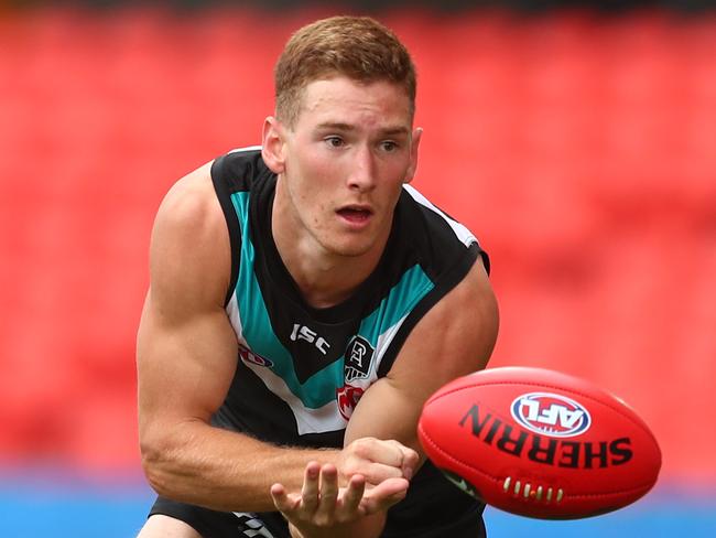 GOLD COAST, AUSTRALIA - JULY 12: Kane Farrell of the Power handballs during the round 6 AFL match between the Port Adelaide Power and the Greater Western Sydney Giants at Metricon Stadium on July 12, 2020 in Gold Coast, Australia. (Photo by Chris Hyde/Getty Images)