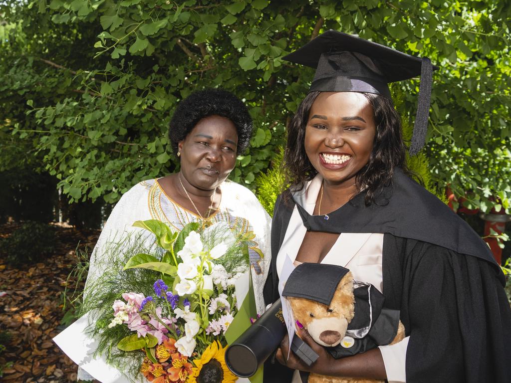 Bachelor of Commerce and Bachelor of Business graduate Mary Ngor celebrates with mum Sarah Duot at the UniSQ graduation ceremony at Empire Theatres, Tuesday, December 13, 2022. Picture: Kevin Farmer