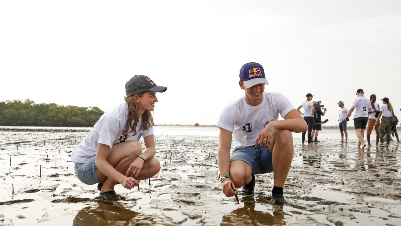 Extreme E drivers Catie Munnings and Timmy Hansen planting trees as part of an Extreme E ‘legacy project’.