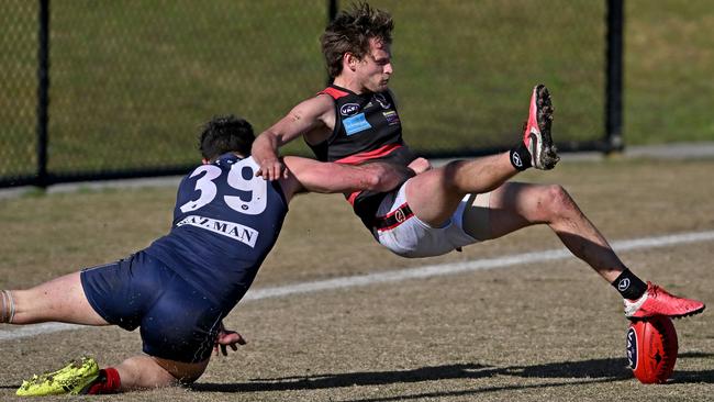 VAFA: Old Melburnians’ Jackson Paine tackles Old Xaverians’ Will Hams. Picture: Andy Brownbill