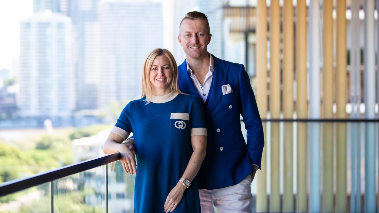 Real estate agents Simon and Courtney Caulfield in their $4.5 million Kangaroo Point luxury apartment. Picture: David Kelly