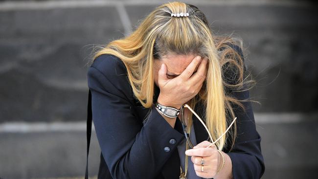 Wendy Peirce collapses on the bonnet of a car after funeral for her daughter Katie.