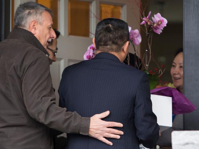 (FILES) In this file photo taken on December 12, 2018 individuals with flowers exiting from a vehicle with consular plates arrive at the residence of Huawei Technologies Chief Financial Officer Meng Wanzhou(R) after she was released on bail in Vancouver, British Columbia. - The United States and Canada on January 16, 2019 promised an "unbiased" legal process for a Chinese executive whose arrest in Vancouver at US request has riled Beijing.US Secretary of State Mike Pompeo and Canadian Foreign Minister Chrystia Freeland discussed the arrest January 15, 2019 in a phone call in which they also voiced concern about the "arbitrary detentions" of Canadians in China, the US State Department said."They noted their continued commitment to Canada's conduct of a fair, unbiased and transparent legal proceeding and US extradition request with respect to Ms. Meng Wanzhou, the chief financial officer of Huawei," a State Department statement said. (Photo by Jason Redmond / AFP)