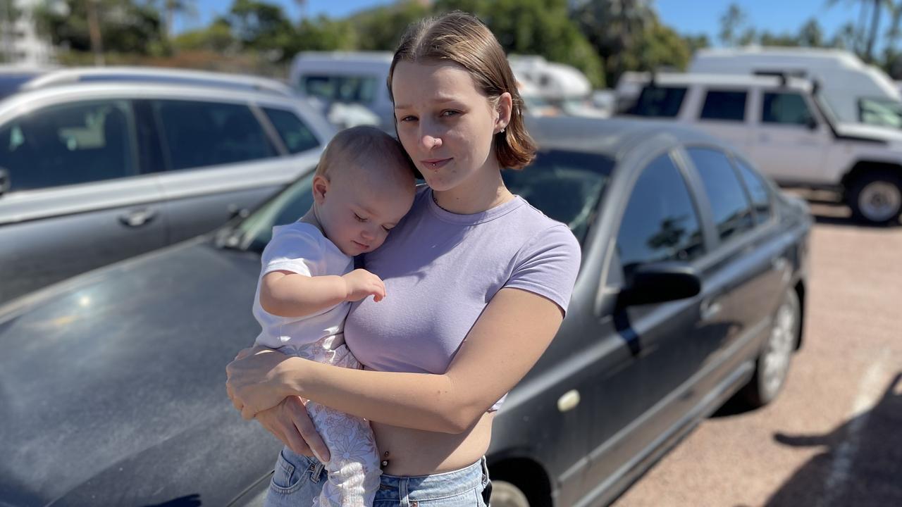 India Sparks and 15 month old daughter Violet with their car stuck at Townsville’s Sealink terminal. There is nowhere to refuel the Ford Falcon, which runs entirely on LPG. Picture: Chris Burns