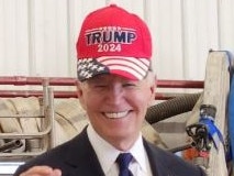 Joe Biden briefly wears Trump hat. Picture: X