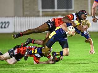 NO CHANCE TO SHINE: The Waves' Chad King gets tackled by Wests Robert Telfer in A-grade earlier this season. He could have been one of the players picked to play if Bundaberg fielded an under-18 side. Picture: Brian Cassidy