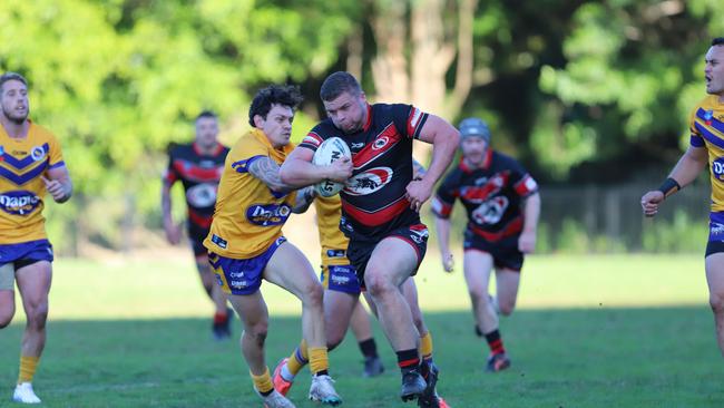 Blake Dowel of Collegians bursting through the Dapto line. Picture: Steve Montgomery