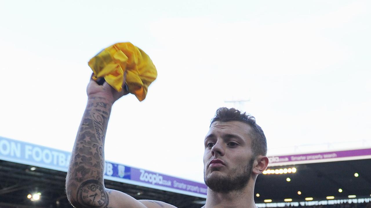 WEST BROMWICH, ENGLAND - OCTOBER 06: Goal scorer Jack Wilshere of Arsenal throws his shirt in to the crowd after the Barclays Premier League match between West Bromwich Albion and Arsenal at The Hawthorns on October 6, 2013 in West Bromwich, England. (Photo by Michael Regan/Getty Images)