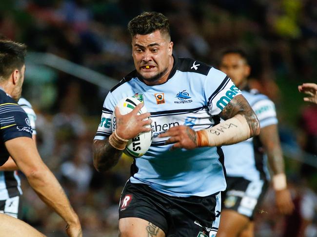 Sharks Andrew Fifita looks for a gap between Cowboys defenders James Tamou, left, and Ethan Lowe during their round 1 NRL match between the North Queensland Cowboys and the Cronulla Sharks at 1300 Smiles Stadium in Townsville, Saturday, March 5, 2016. (AAP Image/Michael Chambers) NO ARCHIVING, EDITORIAL USE ONLY