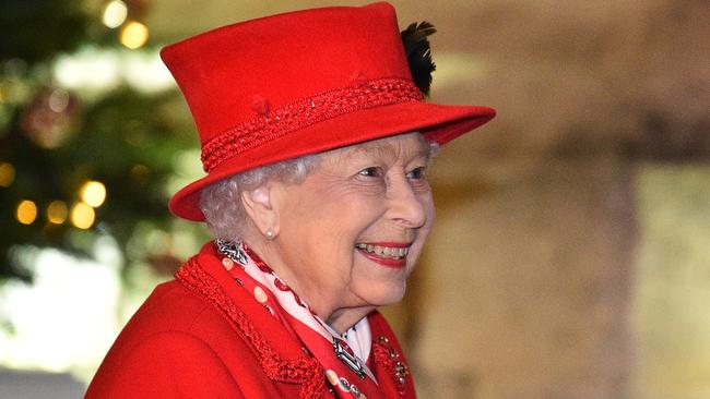 Queen Elizabeth II appeared delighted to see her family after nine months apart, and celebrated wearing a ‘Christmas red’ suit and hat. Picture: Glyn Kirk/Getty