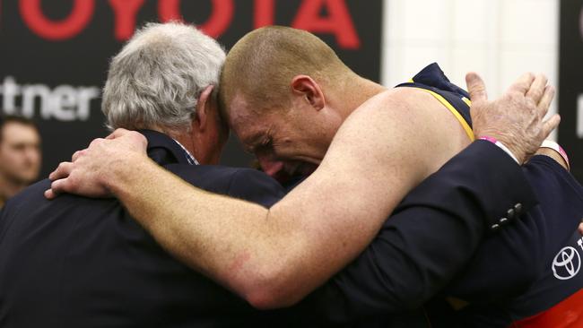 An upset Sam Jacobs is consoled in the rooms by dad John after the Grand Final. Picture: Sarah Reed