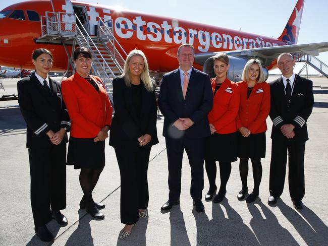 BRISBANE, AUSTRALIA - NewsWire Photos JUNE 19, 2023: Jetstar Group CEO Stephanie Tully and Brisbane Airport CEO Gert-Jan de Graaff, centre, pose with airline staff during an announcement at Brisbane Airport. The low-cost carrier will reveal more great low fares, new long-haul routes and extra frequency to popular international destinations. Picture: NCA NewsWire/Tertius Pickard