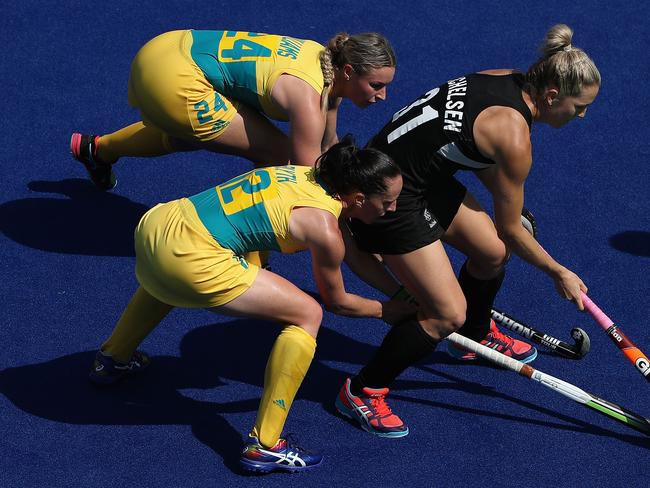 Stacey Michelsen #31 of New Zealand attempts to control the ball pressured by Mariah Williams #24 and Madonna Blyth #12 of Australia during the second half of the quarter final hockey game on Day 10 of the Rio 2016 Olympic Games at the Olympic Hockey Centre on August 15, 2016 in Rio de Janeiro, Brazil. (Photo by Christian Petersen/Getty Images)