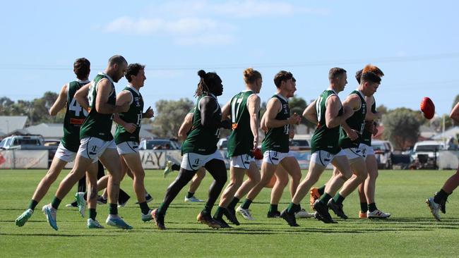 Anthony McDonald-Tipungwuti runs out with his Imperial teammates. Picture: Rita Morello.