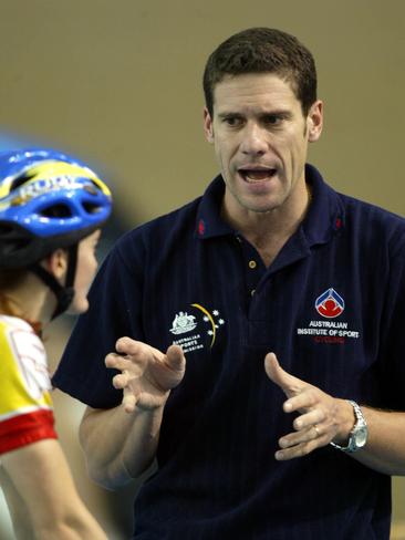 Coach Kevin Tabotta talks to a cyclist.