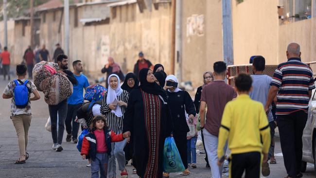 Palestinians carrying their belongings flee to safer areas in Gaza City after Israeli air strikes. Picture: MAHMUD HAMS / AFP