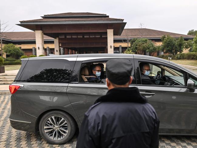 WHO team member Peter Ben Embarek (L-in car) and other members of the group leave their hotel after the World Health Organization (WHO) team wrapped up its investigation into the origins of the COVID-19 coronavirus in Wuhan in China's central Hubei province on February 10, 2021. (Photo by Hector RETAMAL / AFP)