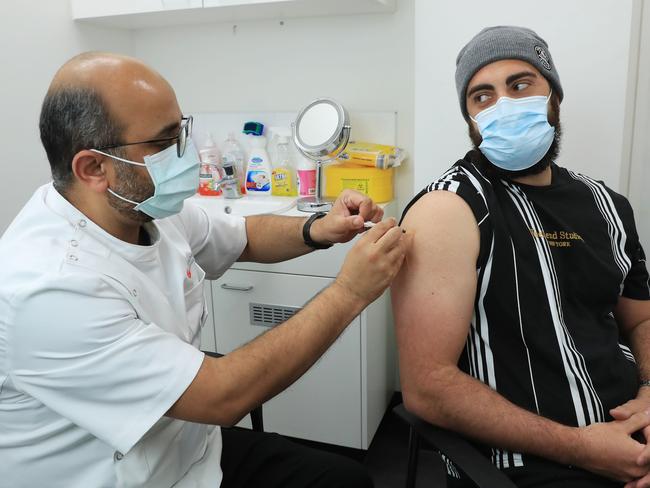 28/7/21: Gregory  Lambrousis 29 receives the AstraZeneca vaccine from pharmacist in charge Nadeem Ahmad at Priceline pharmacy in Liverpool insouth-west Sydney. John Feder/The Australian.