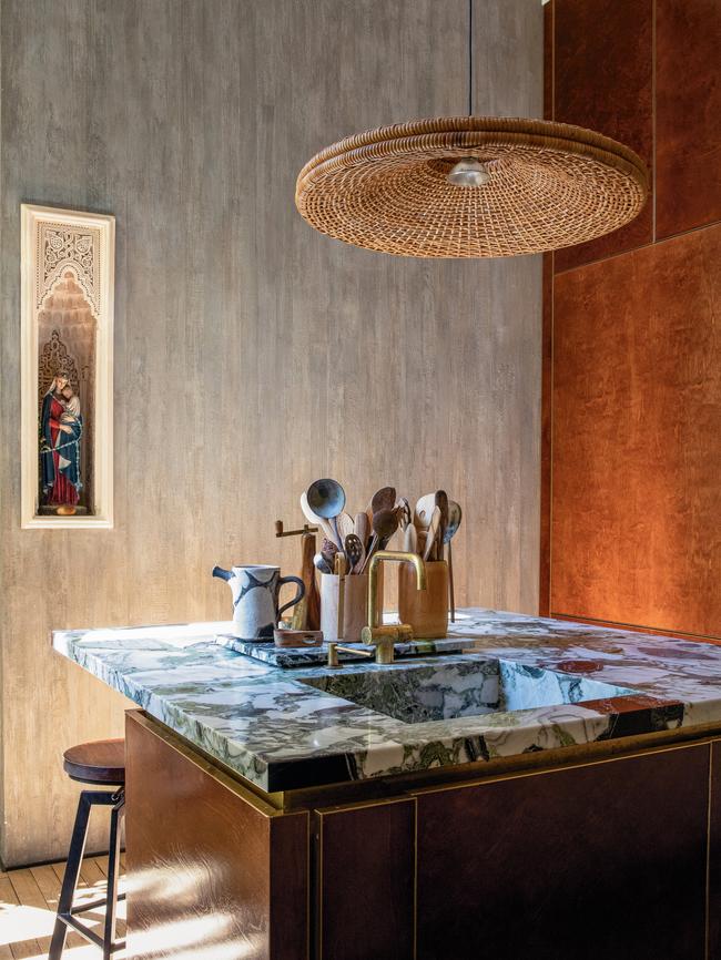 Flea market finds, such as stools and a pendant light, are mixed with marble glamour in a city pad with interiors designed by Studio Ko. Photo: Karel Balas