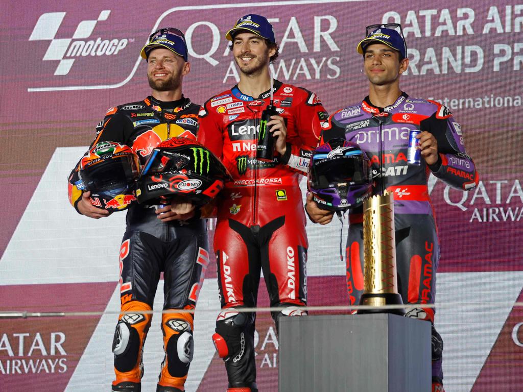 First placed Ducati Lenovo Team Italian rider Francesco Bagnaia (C), second placed Red Bull KTM Factory Racing South African rider Brad Binder (L) and third placed Prima Pramac Racing Spanish rider Jorge Martin pose during the podium ceremony of the Qatar MotoGP Grand Prix at the Lusail International Circuit in Lusail, north of Doha on March 10, 2024. (Photo by KARIM JAAFAR / AFP)