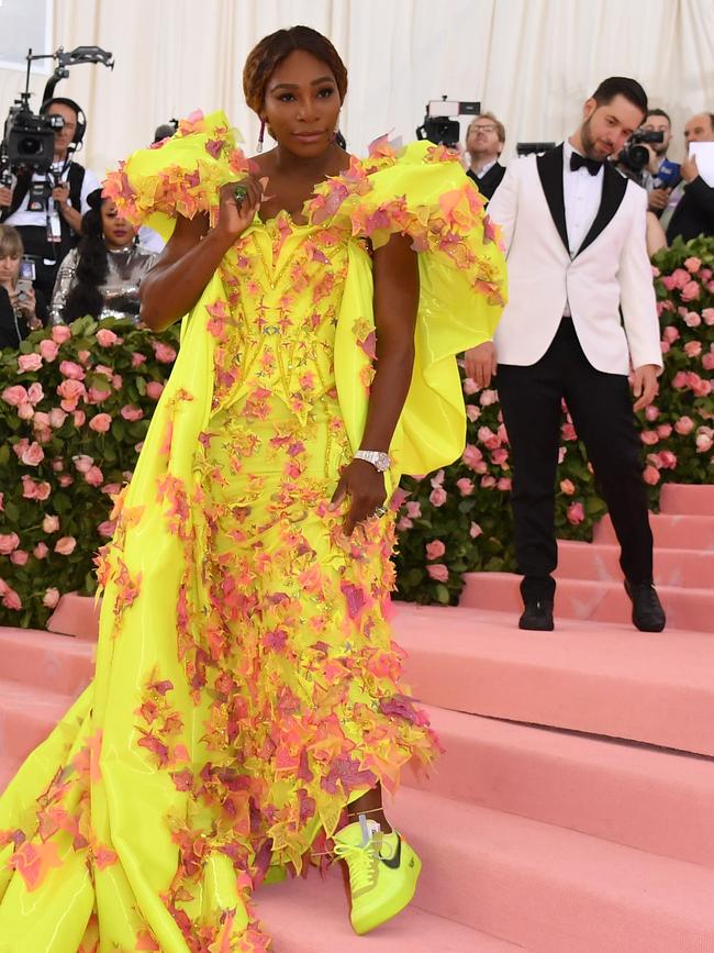 Serena Williams, wearing Versace and a pair of Nikes, while her husband Alexis Ohanian looks on. Picture: AFP