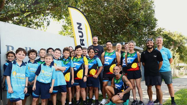 The partnership between the Port Douglas Gran Fondo and the Indigenous Marathon Foundation (IMF) was launched at Redlynch State School. (L to R) Group of students runners from Redlynch State School, MP elect for Leichhardt Matt Smith, IMF representatives, Gran Fondo festival director Bade Stapleton. Picture: Elodie Jakes