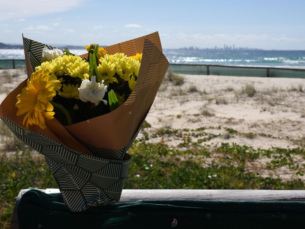 Floral tributes have been placed at Greenmount Beach, the site of the Gold Coast’s first fatal shark attack in more than 60 years. Picture: NCA NewsWire/Steve Holland