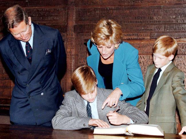 Prince William signs in on his first day at Eton College watched by his parents and brother, Prince Harry, in September 1995. Picture: WireImage