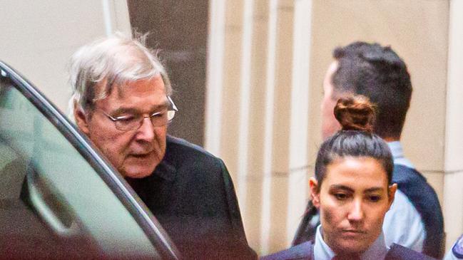 Australian Cardinal George Pell (L) is escorted into the Supreme Court of Victoria in Melbourne on June 6, 2019. - Pell asked appeals court judges to quash his landmark conviction for child sex abuse, branding the charges against him "bizarre" and "impossible". (Photo by ASANKA BRENDON RATNAYAKE / AFP)