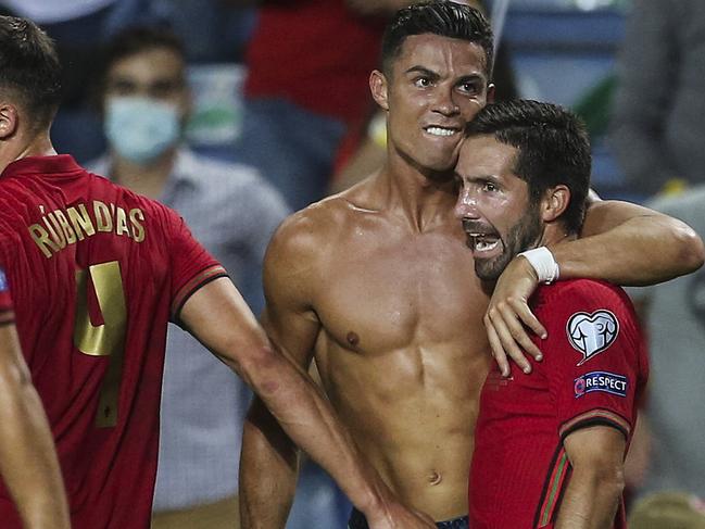 Portugal's forward Cristiano Ronaldo (2ndR) celebrates with his teammates after scoring a goal during the FIFA World Cup Qatar 2022 European qualifying round group A football match between Portugal and Republic of Ireland at the Algarve stadium in Loule, near Faro, southern Portugal, on September 1, 2021. (Photo by CARLOS COSTA / AFP)