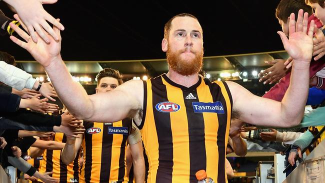 High-fives for Hawthorn captain Jarryd Roughead as he leads his victorious team off the MCG. Picture: Getty Images