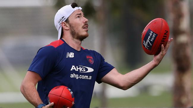 Michael Hibberd juggles footballs at Demons training. Picture: Wayne Ludbey