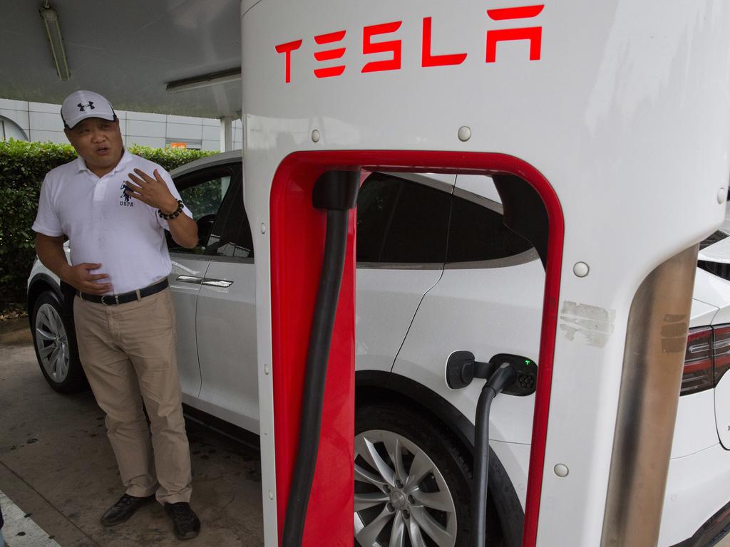 Shan Junhua chats about privacy near his white Tesla while charging it in Shanghai. When Shan bought his white Tesla Model X, he knew it was a fast, beautiful car. What he didn't know is that Tesla constantly sends information to the Chinese government. Picture: AP