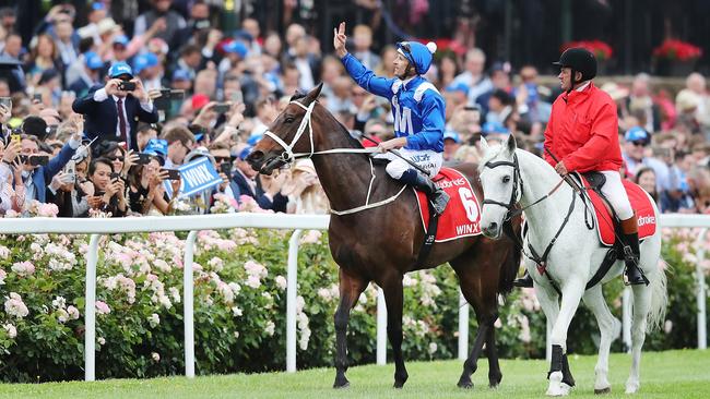 Hugh Bowman and Winx celebrate their Cox Plate win.