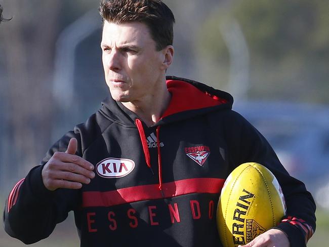 Essendon training at Tullamarine. Joe Daniher works with Matthew Lloyd on his goal kicking during training today . Pic: Michael Klein