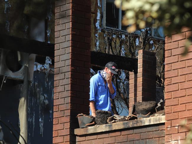 Another shocked local inspects the damage to the home of a friend’s grandmother. Picture Gary Ramage