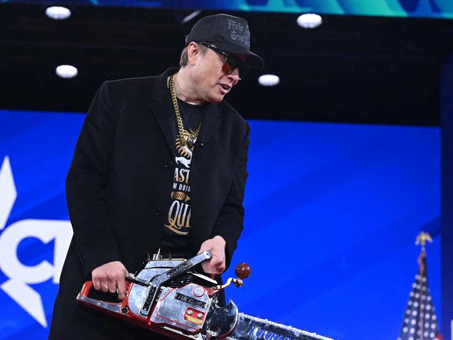 Billionaire Elon Musk, the head of the Department of Government Efficiency (DOGE), holds a chainsaw as he speaks at the annual Conservative Political Action Conference (CPAC) at the Gaylord National Resort & Convention Center at National Harbor in Oxon Hill, Maryland, on February 20, 2025. (Photo by SAUL LOEB / AFP)