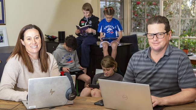 Parents Andrew Buckland and Julia Hay prepare for the return to remote learning with their children. Picture: Sarah Matray