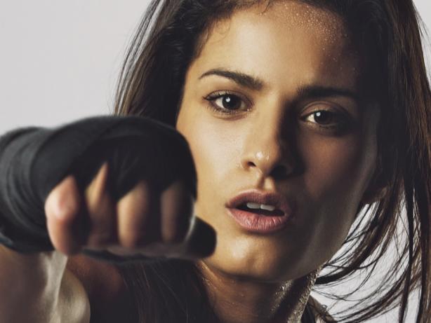 Female boxer throwing a punch in front