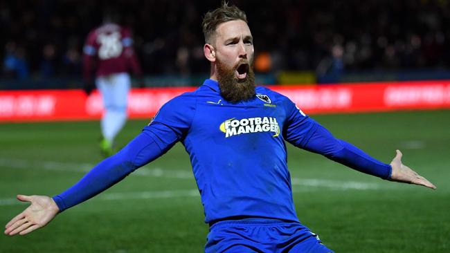 Scott Wagstaff celebrates an FA Cup double for AFC Wimbledon. Picture: AFP