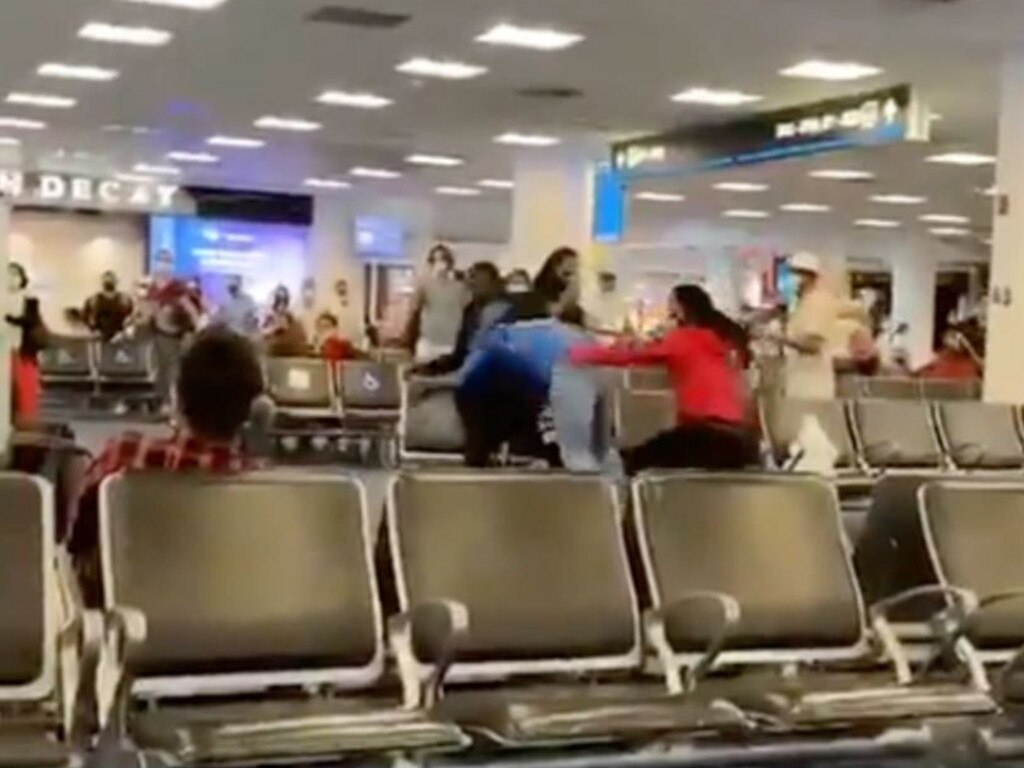 Several small groups of people can be spotted throughout the terminal, lunging at each other and throwing punches.