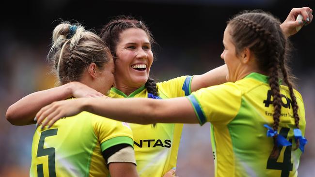 Emma Tonegato, Charlotte Caslick and Dominique du Toit of Australia celebrate.