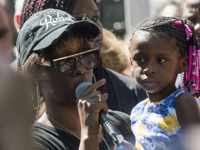 Diamond Reynolds, holding her daughter, speaks to a crowd outside the Governor's Mansion in St. Paul, Minnesota. Picture: Getty